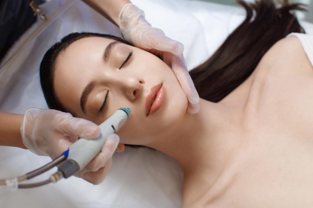 professional-female-cosmetologist-doing-hydrafacial-procedure